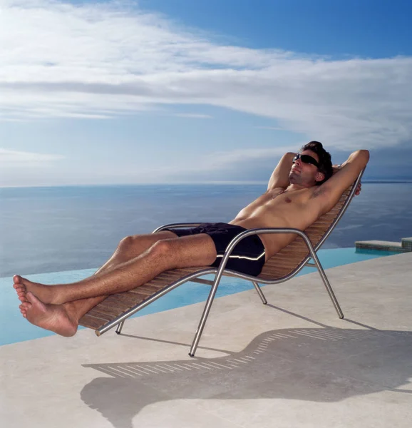 Man relaxing by the pool