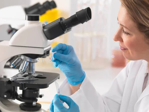 Female Microbiologist Viewing Specimen Slide Microscope Lab — 스톡 사진