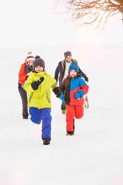 在雪中奔跑的家庭 — 图库照片