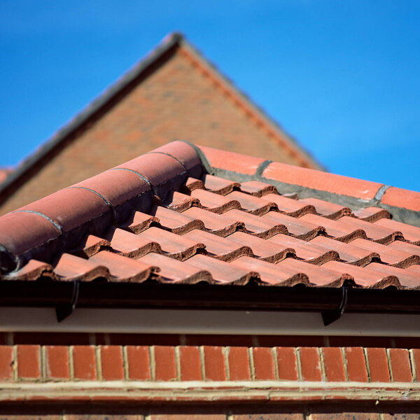 House with tiled roof over blue sky