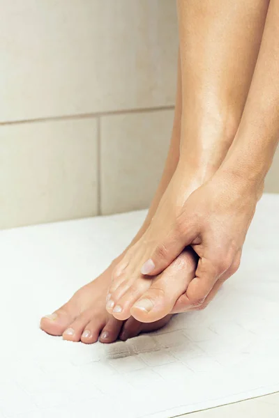 Woman Rubbing Her Feet Stock Image