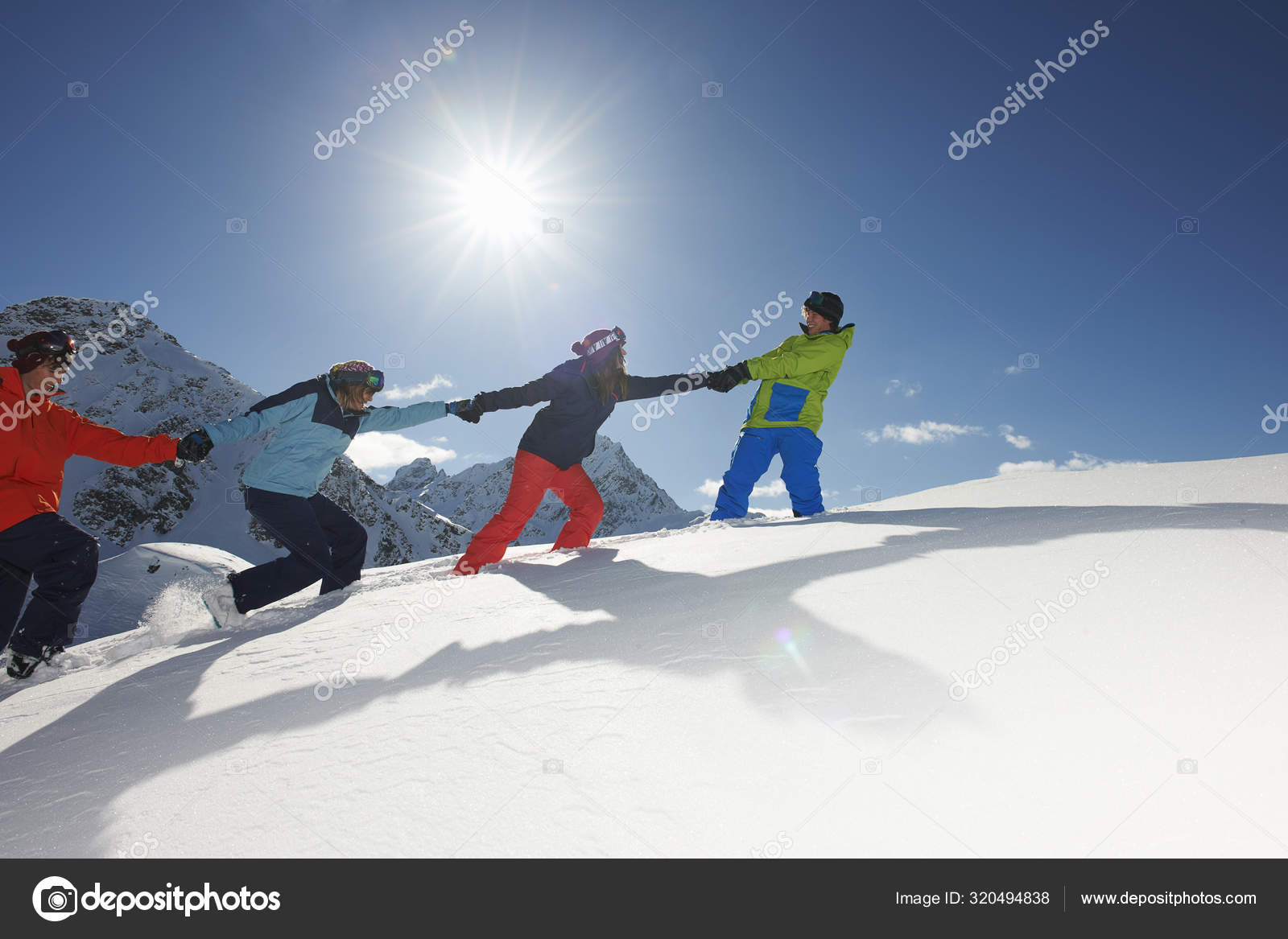 Friends Pulling Each Other Uphill Snow Kuhtai Austria Stock Photo by