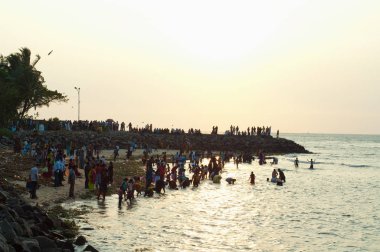 Crowds bathing in the sea in the evening in Cochin, Kerala clipart