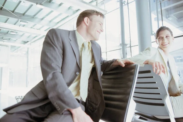 handsome young Businessman and businesswoman meeting in airport lounge