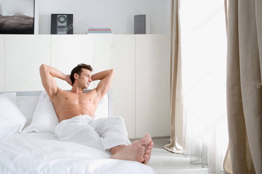 Man relaxing in bedroom