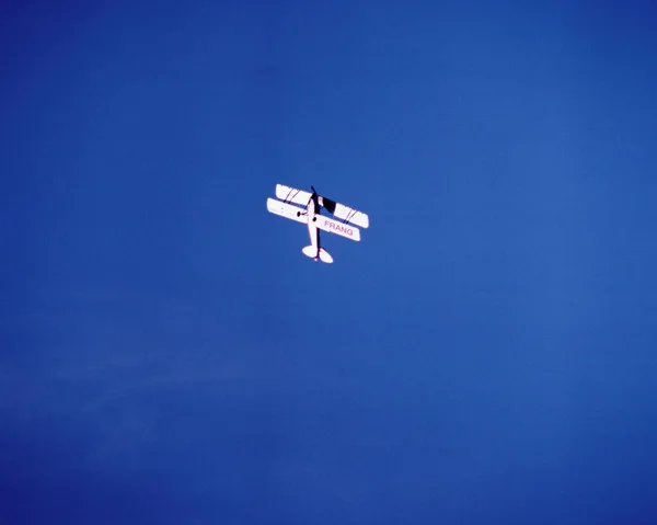 青い空の上を回転する複葉機 — ストック写真