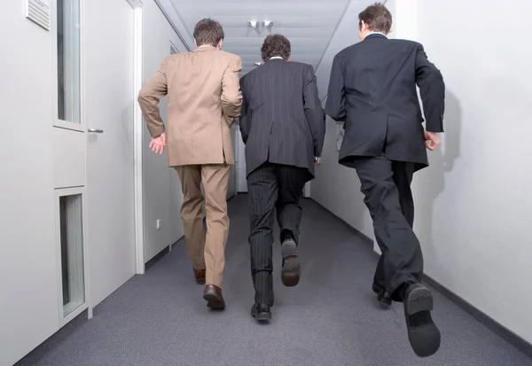 Businessmen running in corridor, business concept background