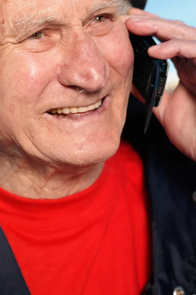 Elderly man smiling with cellphone