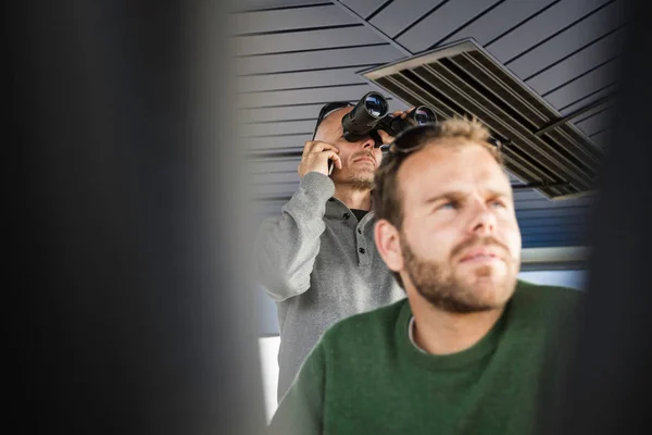 Two Men Looking Away One Binoculars — kuvapankkivalokuva