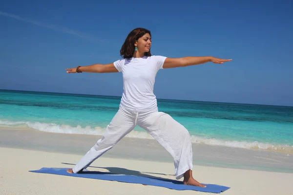 Young woman doing yoga warrior pose, Paradise Island, Nassau, Bahamas