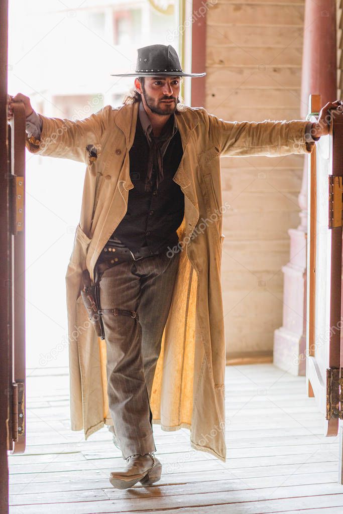 Cowboy standing in saloon doorway on wild west film set, Fort Bravo, Tabernas, Almeria, Spain
