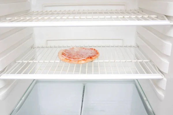 A pizza in a fridge — 스톡 사진