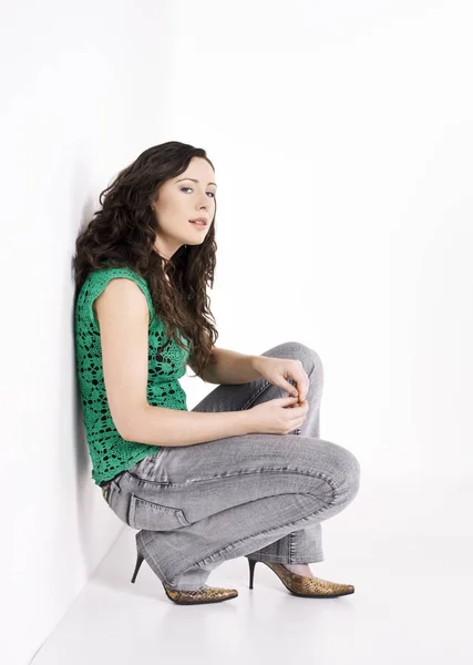 Woman Crouching White Wall Portrait Stock Picture