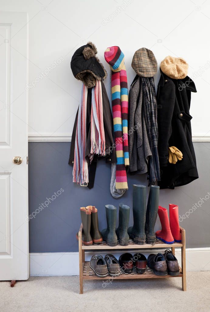 Coats and hats hanging on wall in hallway