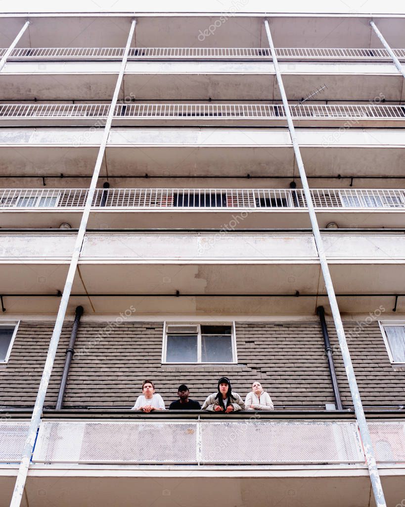 Teenagers standing on balcony