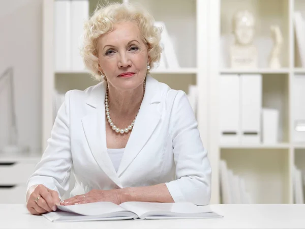 Senior businesswoman with book