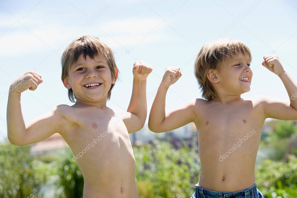 Little Boys flexing muscles