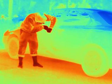 Thermal photograph of a burglar breaking into a car clipart