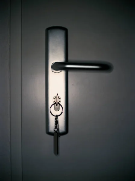 Key in a door — 스톡 사진