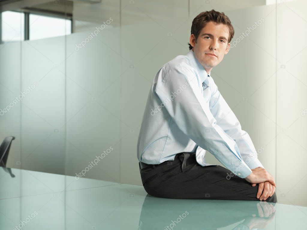 Office worker sitting on a table