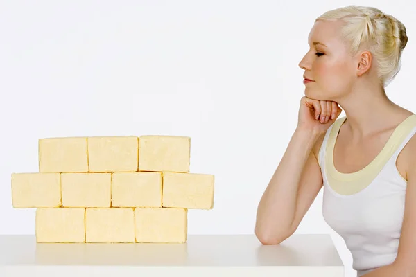 Young Woman Sat Next Blocks Butter — Stock Photo, Image