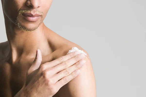 Man using body scrub