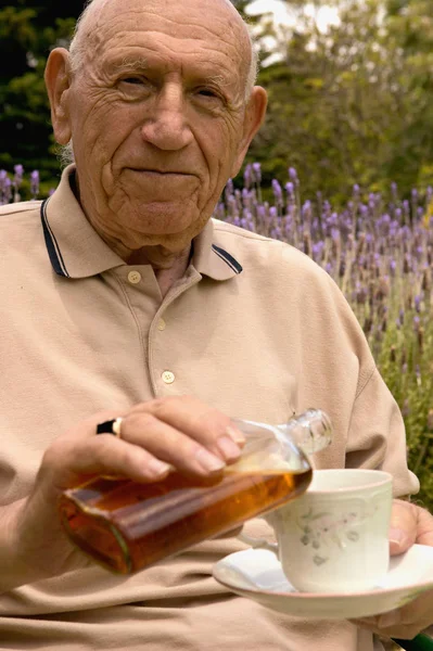 Senior Man Pouring Alcohol His Teacup — Stock Photo, Image