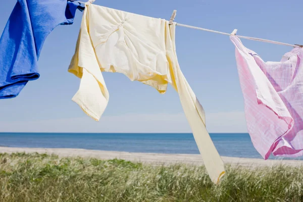 Laundry drying on clothes line by sea