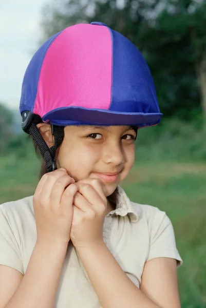 Girl Adjusting Riding Hat — Stock fotografie