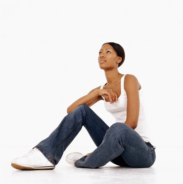 Young Woman Sitting Looking Thoughtful — Stock Photo, Image