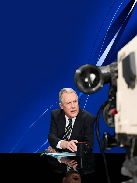 mature news presenter and camera