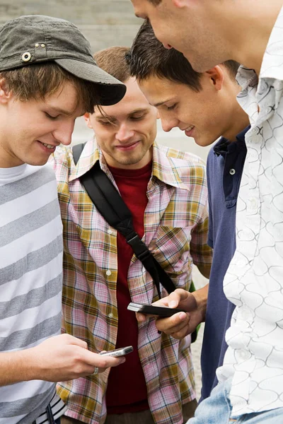 Friends exchanging phone numbers