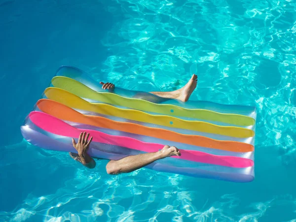 Man under pool inflatable