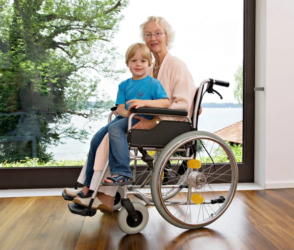 Boy Sitting Senior Woman Lap — Stock Photo, Image