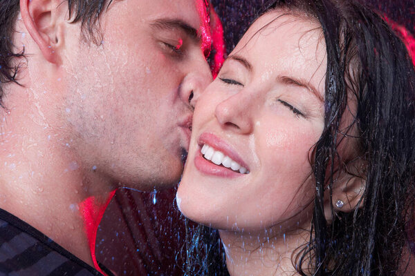 Young couple kissing in the rain