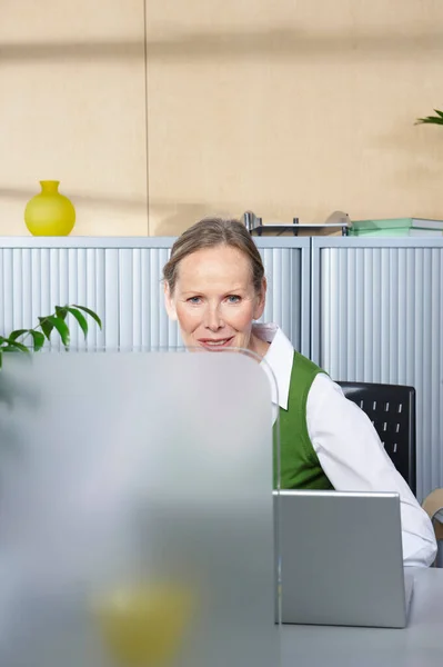 Ανώτερη Γυναίκα Που Κάθεται Στο Γραφείο — Φωτογραφία Αρχείου