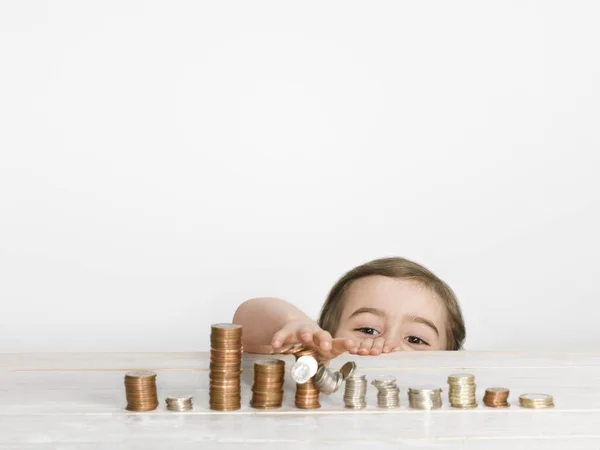 Girl Stacking Coins Counter — 스톡 사진