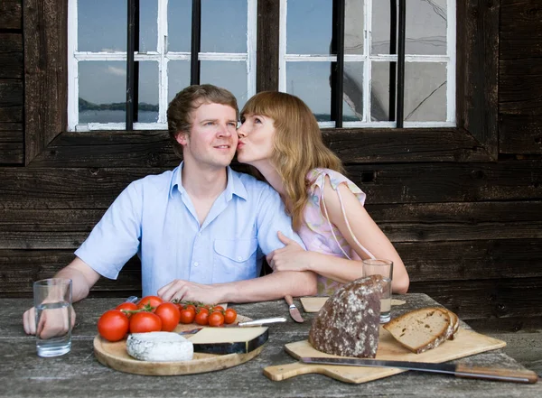 Пара ест, целуется на улице — стоковое фото