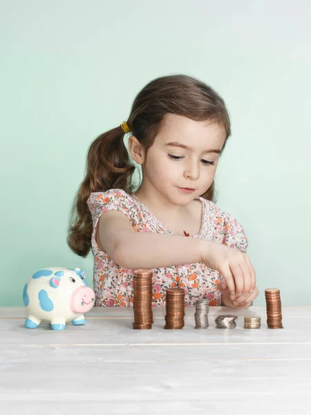 Girl Stacking Coins Counter — 스톡 사진