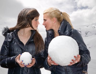 Teen girls challenge with snowballs clipart