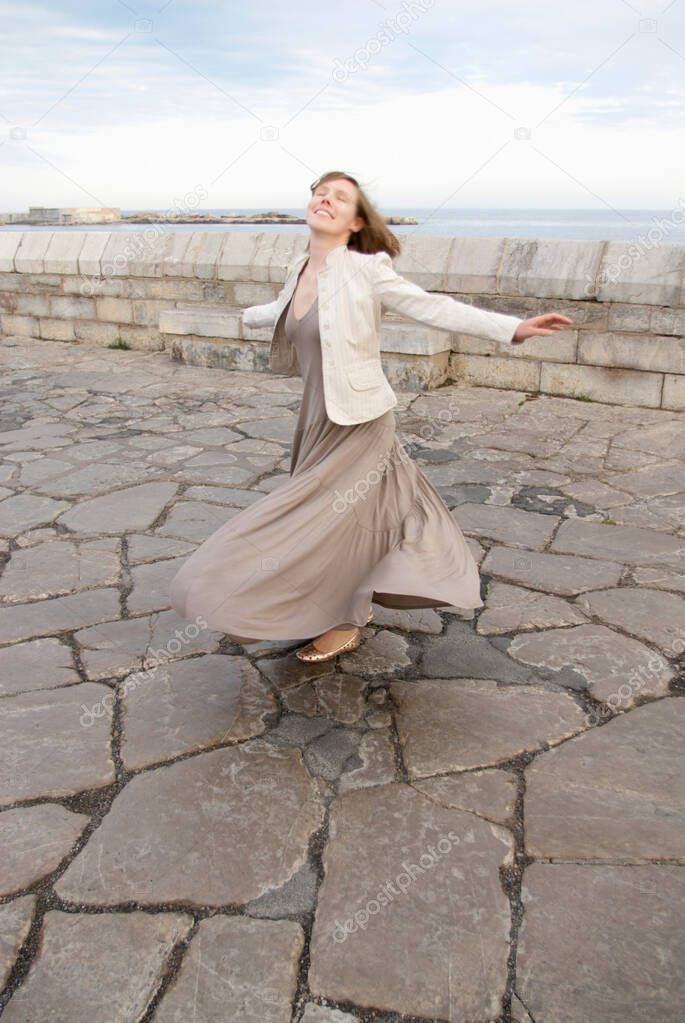 woman twirling skirt outside