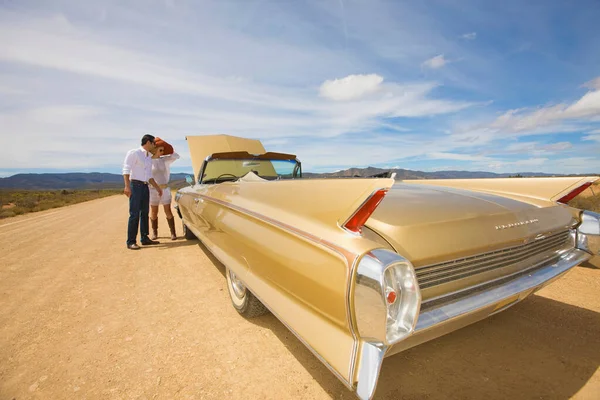 Casal com problemas de carro no deserto — Fotografia de Stock