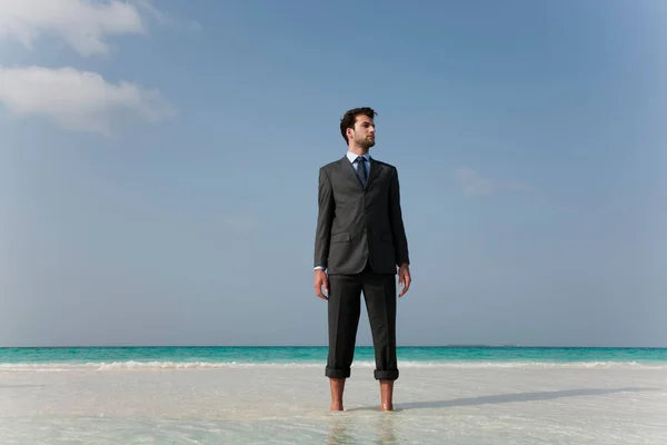 Empresário em pé na praia tropical — Fotografia de Stock