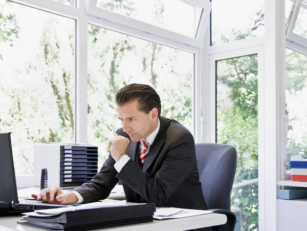 Uomo Determinato Esaminando Computer Portatile — Foto Stock