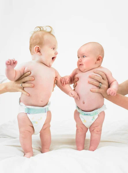 Babies standing with help — Stock Photo, Image