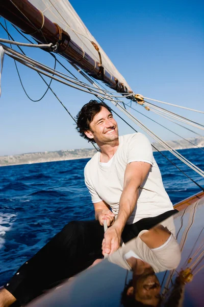 Man Smiling Steering Sailing Boat Royalty Free Stock Images