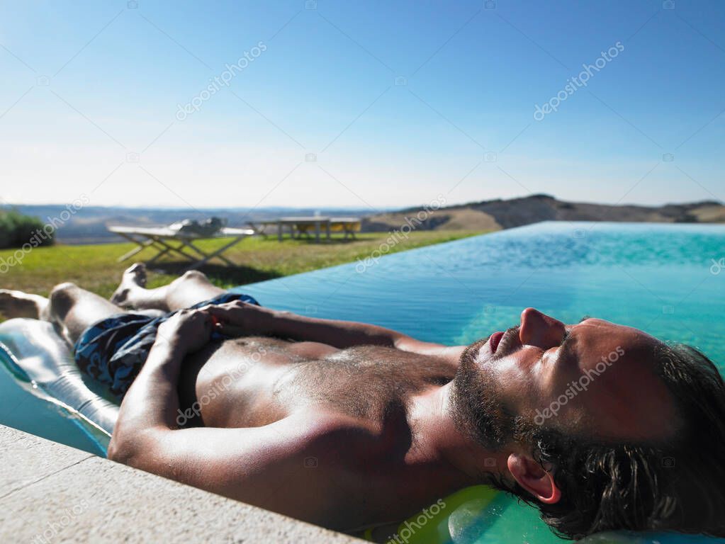 Man resting in swimming pool