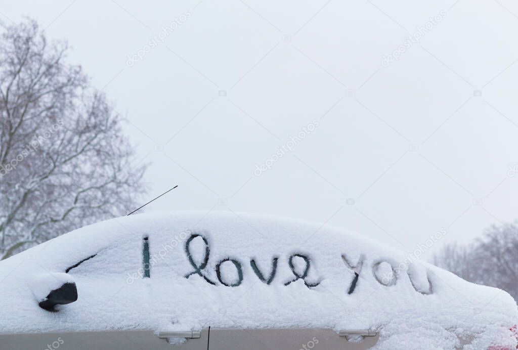 'I love you' drawn in snow on car