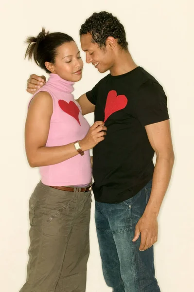 Young couple wearing heart shapes — Stock Photo, Image