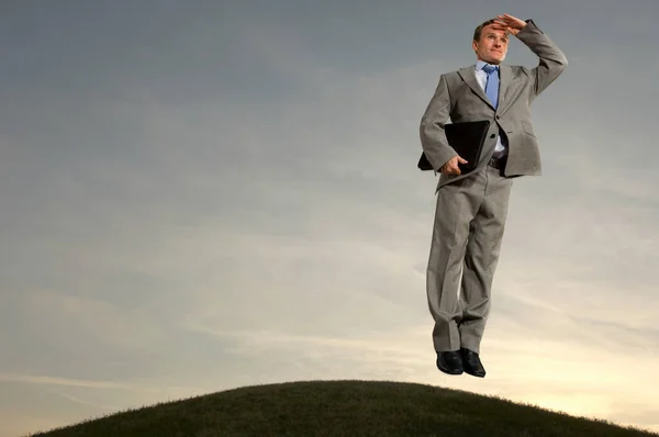 Επιχειρηματίας αιωρείται πάνω από το λόφο — Φωτογραφία Αρχείου